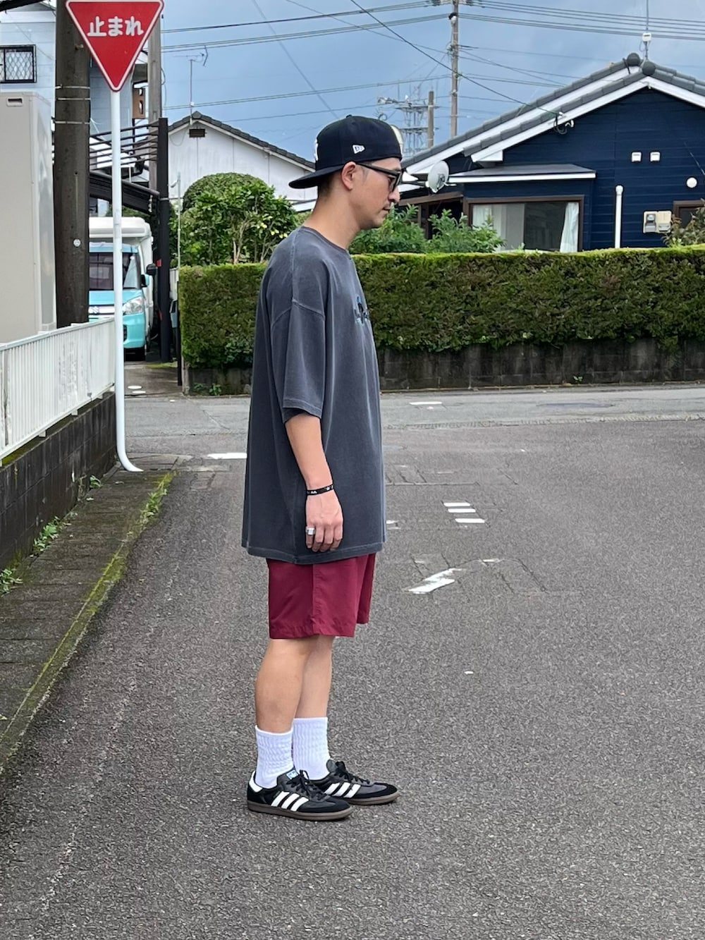 ブラック系のスニーカー、ブルー系のその他パンツ、グレー系のTシャツ/カットソーを着用したメンズの夏コーディネートの2枚目の写真