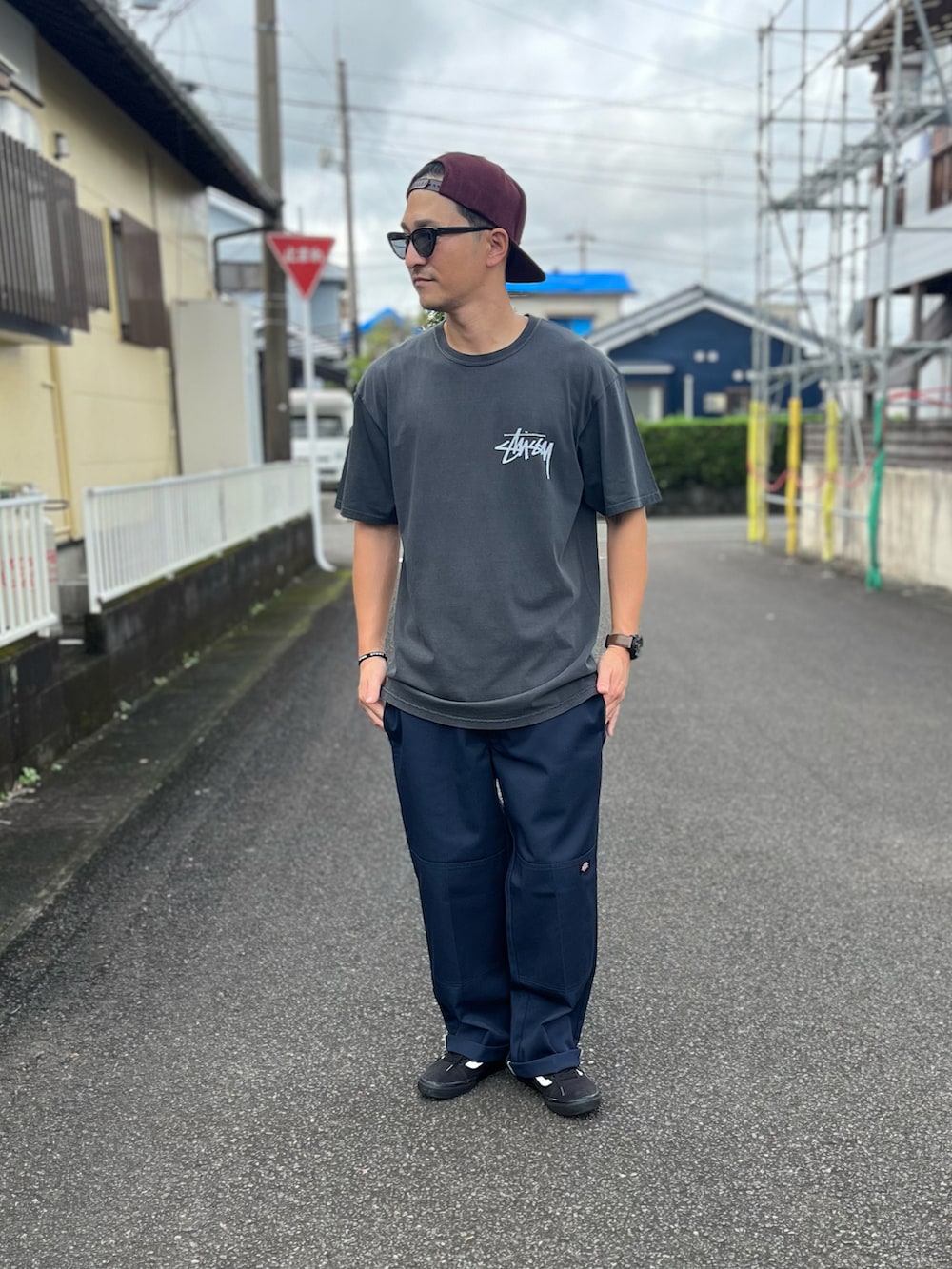 グレー系のTシャツ/カットソー、グレー系のチノパンツ、ブラック系のスニーカーを着用したメンズの秋コーディネートの2枚目の写真