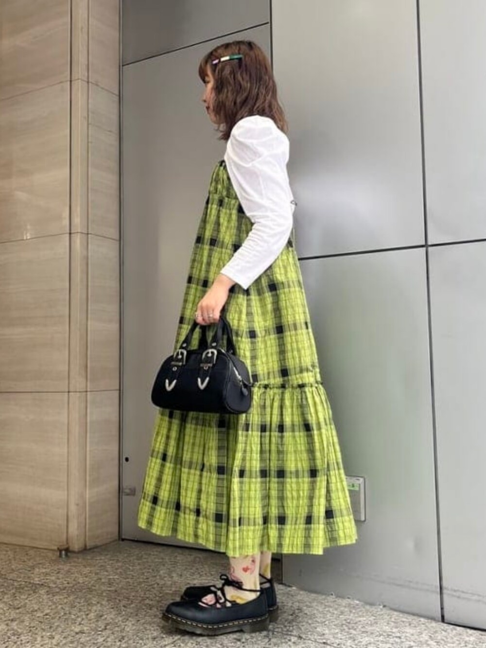 ホワイト系のTシャツ/カットソー、ブラック系のボストンバッグ、グリーン系のワンピースを着用したレディースの春コーディネートの2枚目の写真