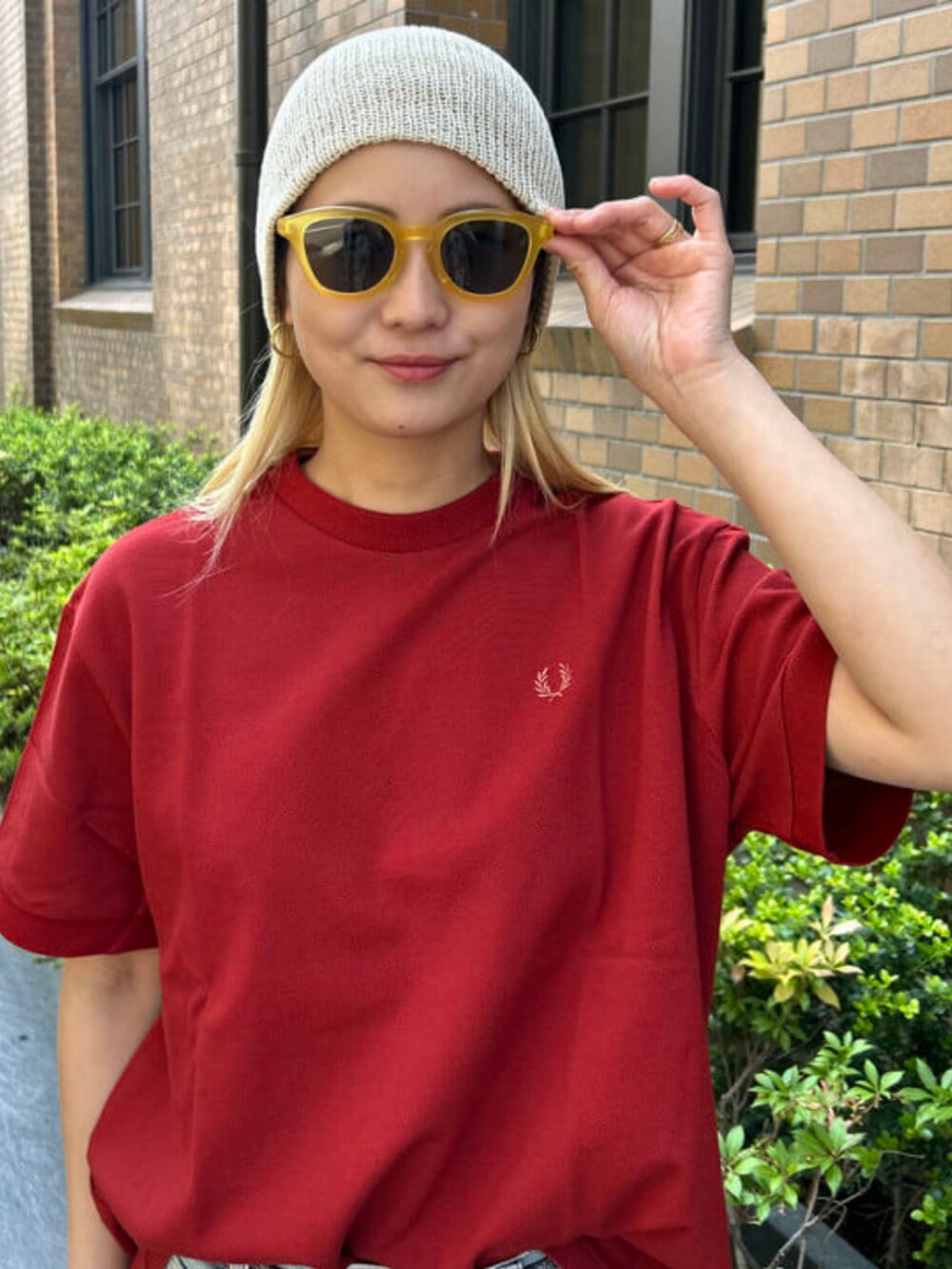 ブラック系のスニーカー、ブルー系のデニムパンツ、レッド系のTシャツ/カットソーを着用したレディースの春コーディネートの3枚目の写真