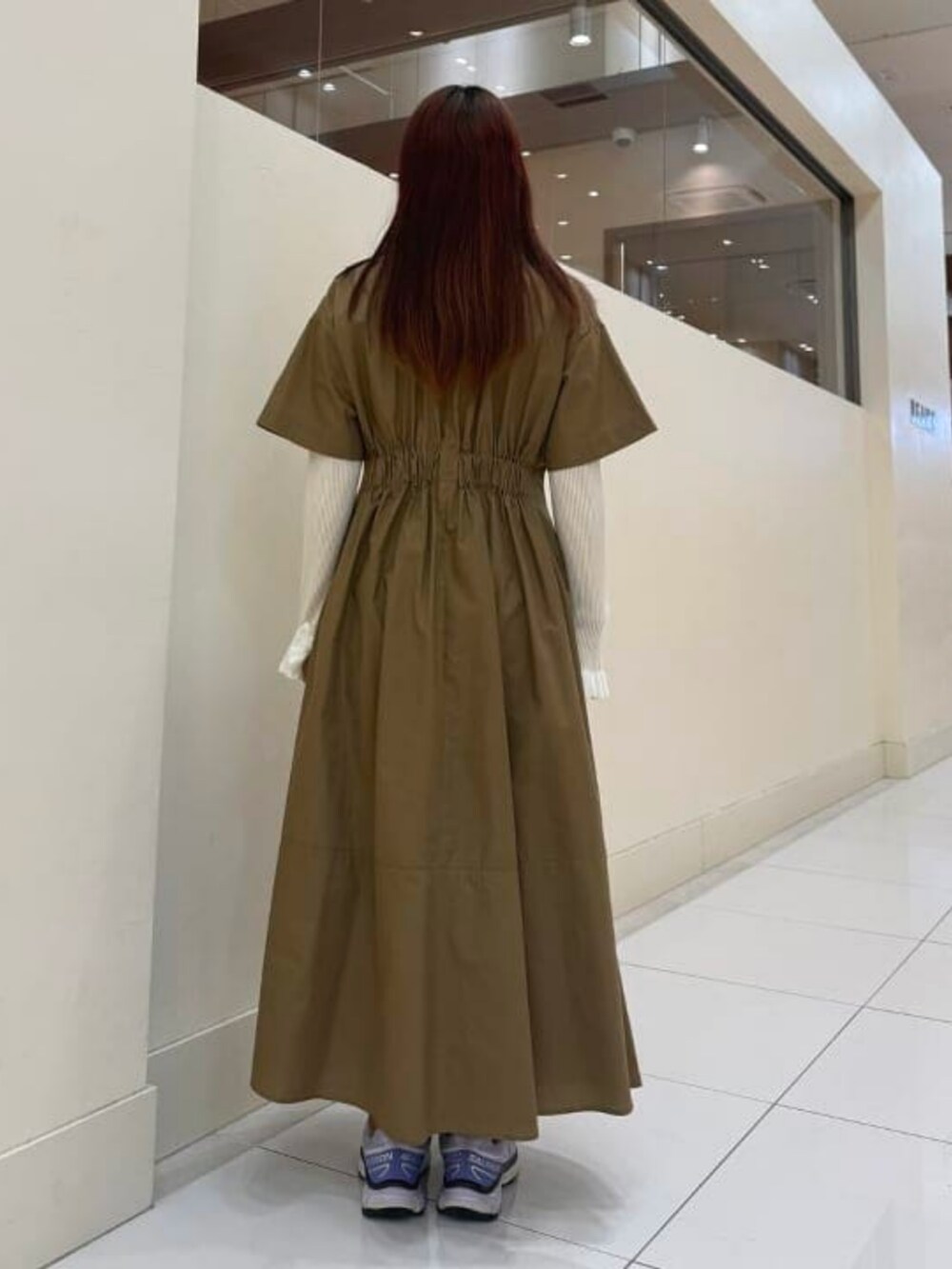 ブラウン系のワンピース、ホワイト系のニット/セーターを着用したレディースの春コーディネートの2枚目の写真