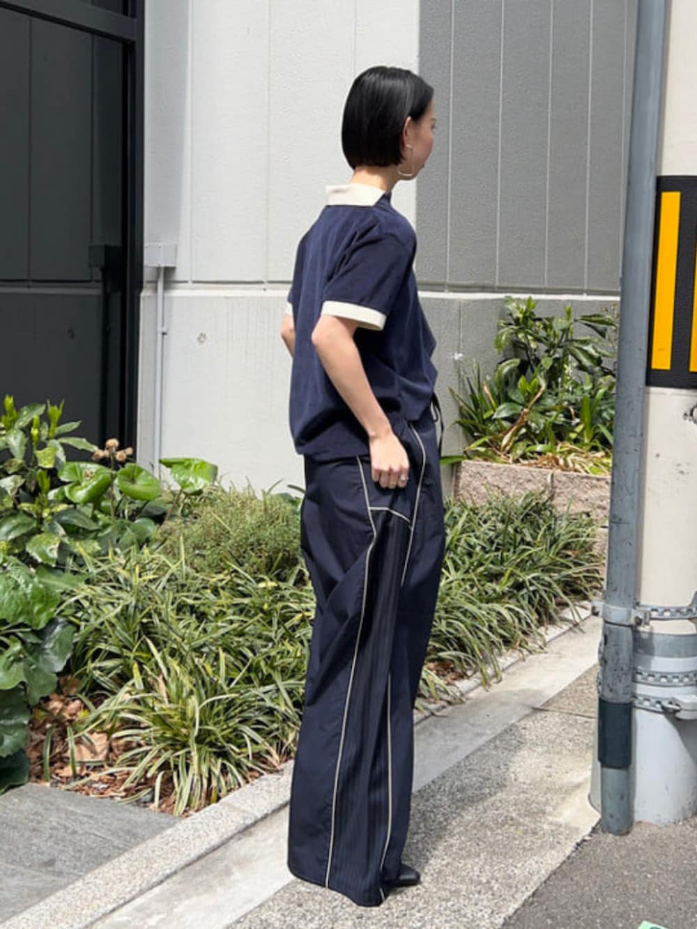 ブルー系のその他パンツ、ブルー系のポロシャツ、ブラック系のボディバッグ/ウエストポーチを着用したレディースの春コーディネートの2枚目の写真