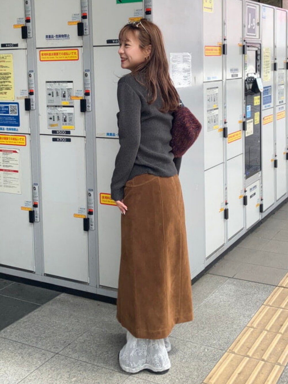 ブラウン系のスカート、ブルー系のトートバッグを着用したレディースの夏コーディネートの2枚目の写真