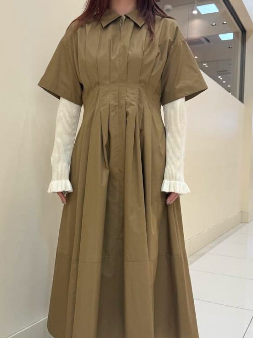 ブラウン系のワンピース、ホワイト系のニット/セーターを着用したレディースの春コーディネートの3枚目の写真