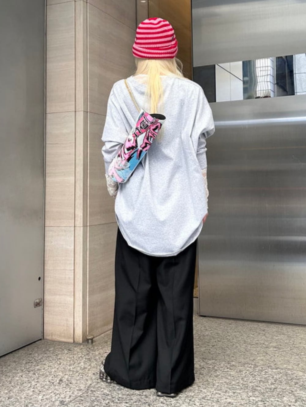 ブラック系のその他パンツ、グレー系のTシャツ/カットソー、レッド系のニットキャップ/ビーニーを着用したレディースの春コーディネートの3枚目の写真