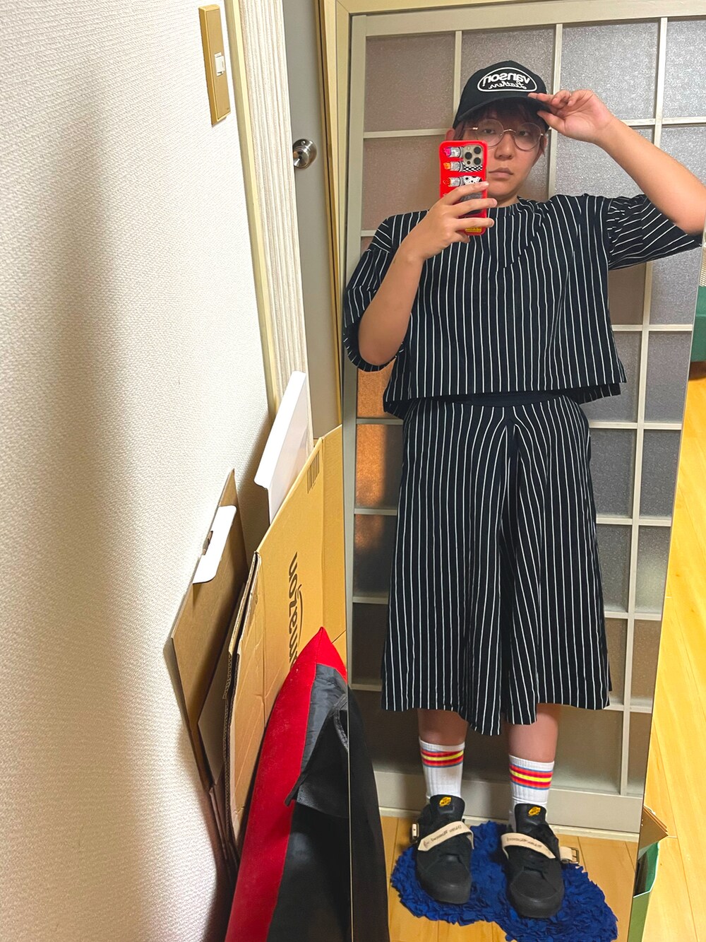 ブラック系のスニーカー、ブラック系のキャップを着用したレディースの秋コーディネートの2枚目の写真