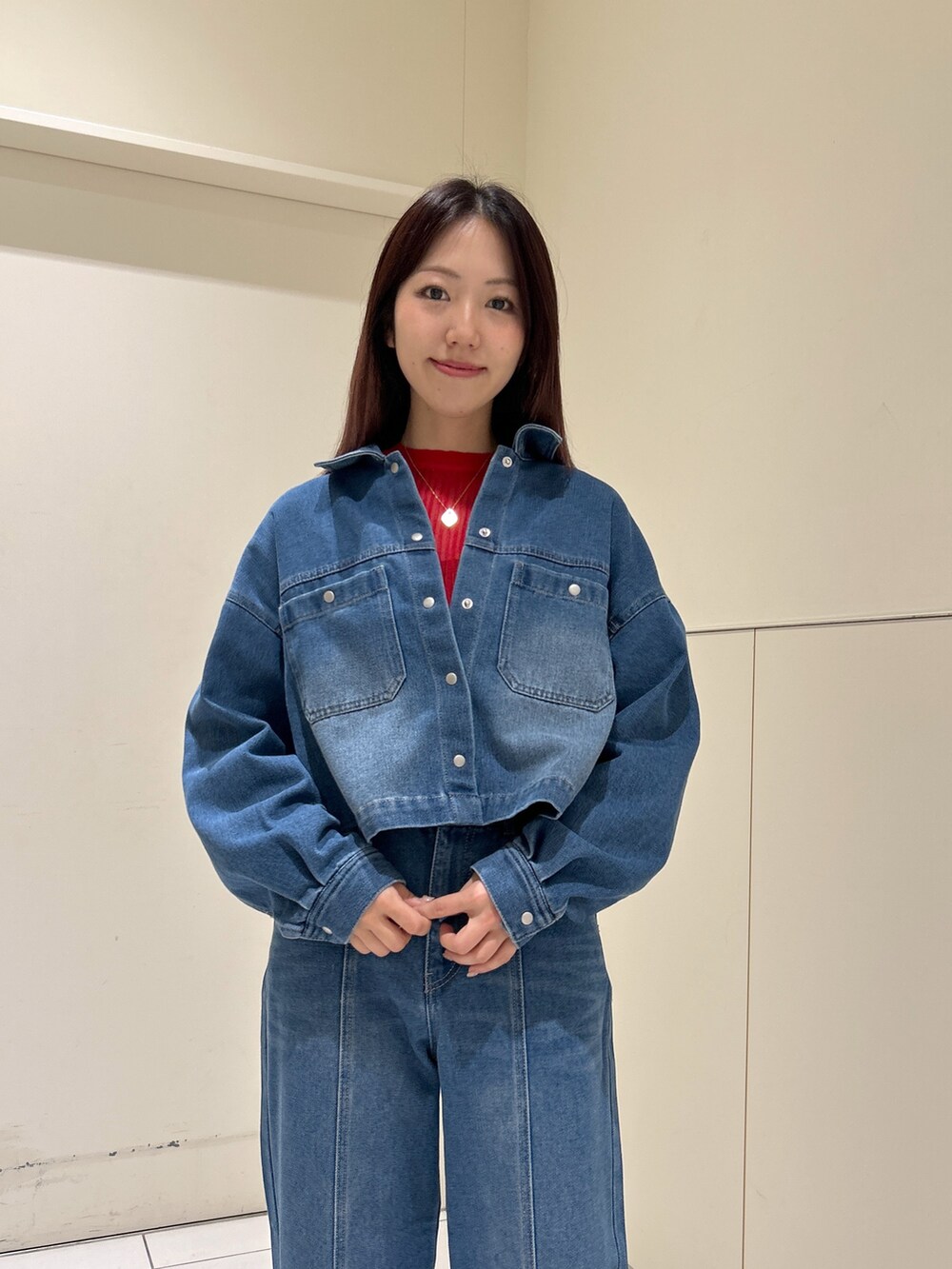 ブルー系のデニムパンツ、ブルー系のブルゾン、ホワイト系のトートバッグを着用したレディースの春コーディネートの4枚目の写真