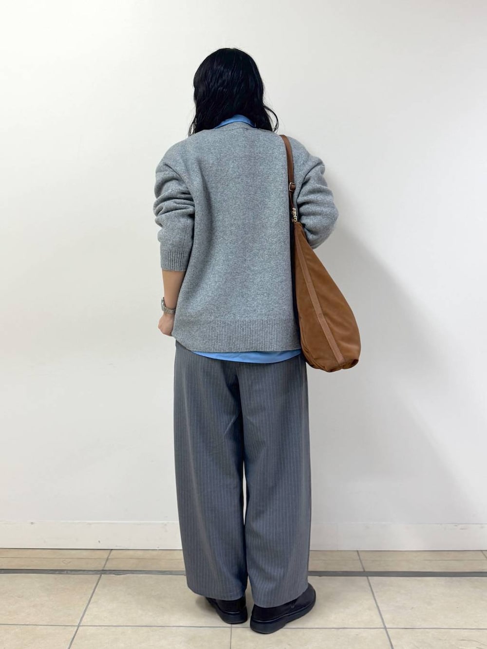 グレー系のスラックス、グレー系のカーディガン/ボレロ、グレー系のその他パンツを着用したレディースの冬コーディネートの3枚目の写真