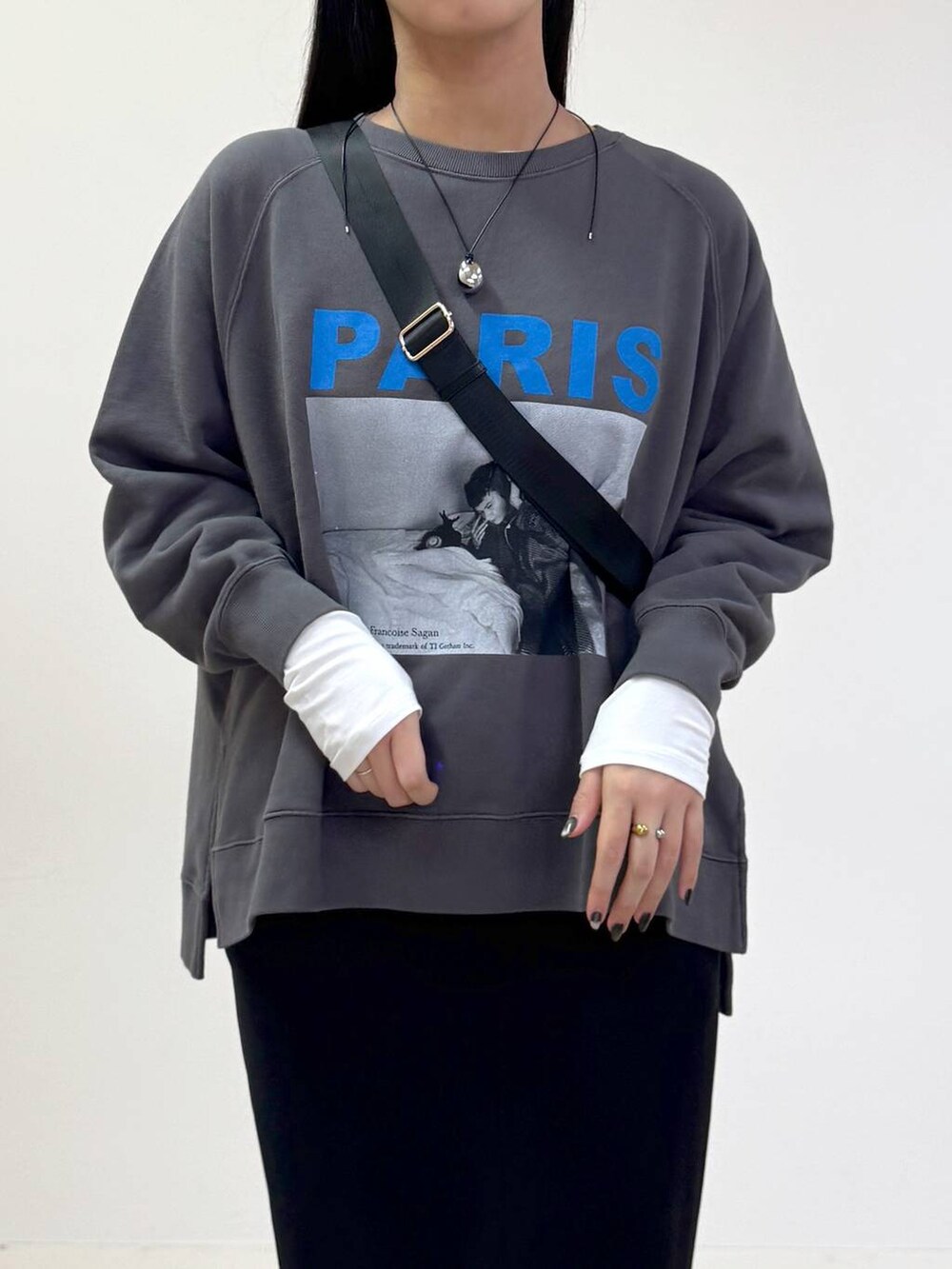 ブラック系のボディバッグ/ウエストポーチ、ブラック系のスカート、ホワイト系のTシャツ/カットソーを着用したレディースの秋コーディネートの4枚目の写真