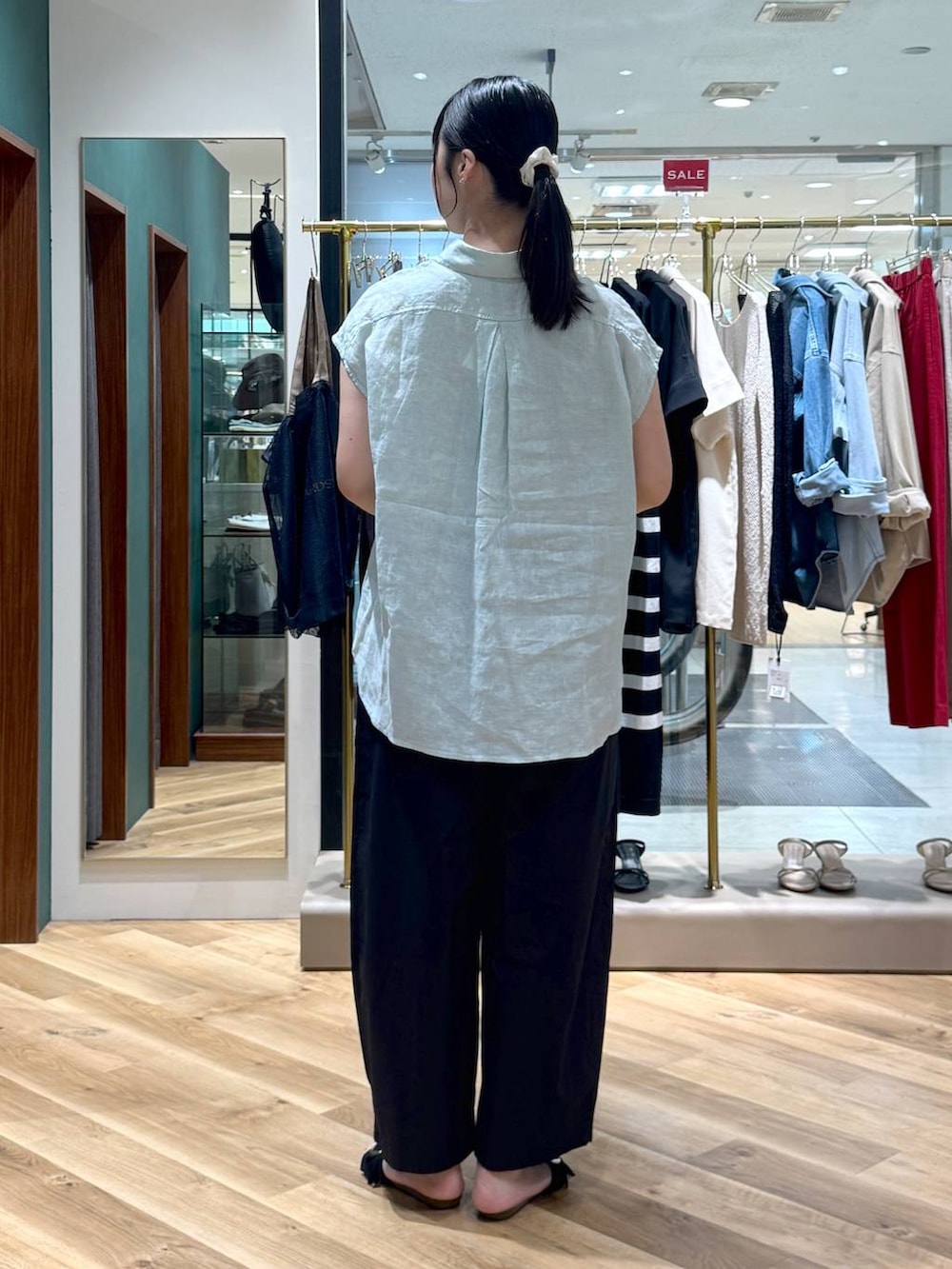 ブラック系のその他パンツ、ブラック系のサンダル、ベージュ系のトートバッグを着用したレディースの夏コーディネートの3枚目の写真