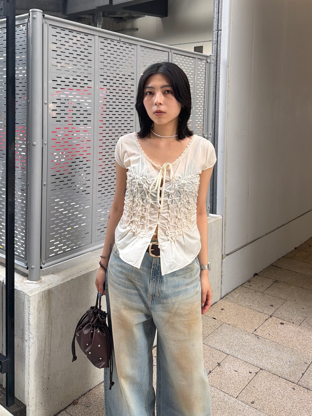 ブラウン系のブーツ、ブルー系のデニムパンツ、ホワイト系のTシャツ/カットソーを着用したレディースの夏コーディネートの6枚目の写真