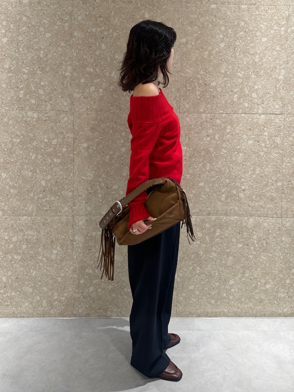 レッド系のニット/セーター、ブラック系のその他パンツ、ブラウン系のローファーを着用したレディースの秋コーディネートの4枚目の写真