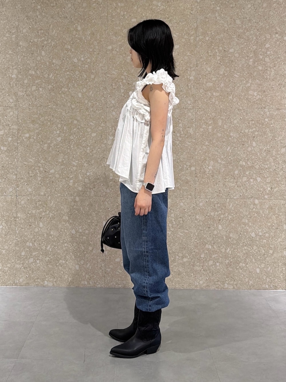 ホワイト系のシャツ/ブラウス、ブルー系のデニムパンツ、ブラック系のブーツを着用したレディースの夏コーディネートの4枚目の写真