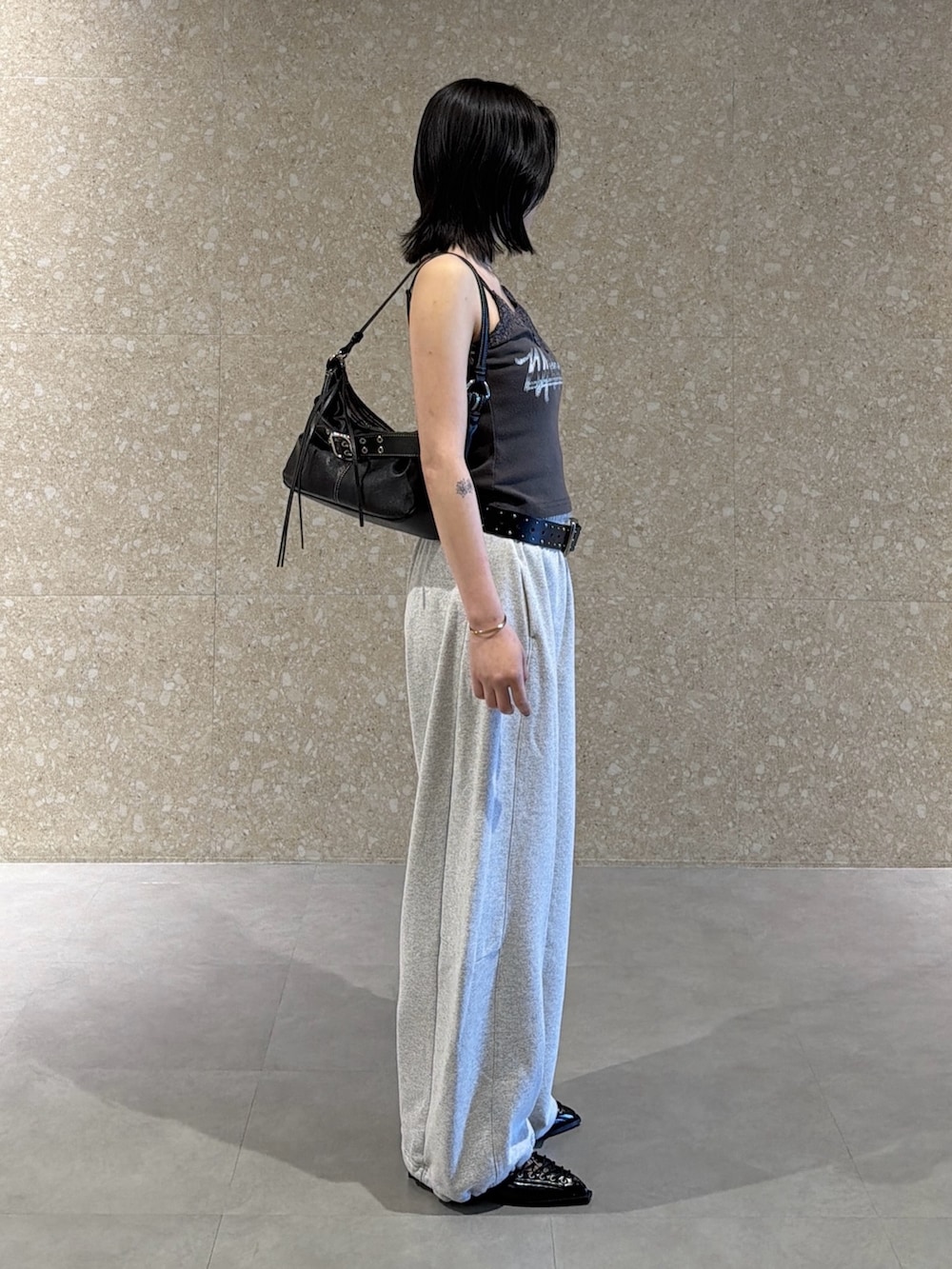 グレー系のスウェットパンツ、ブラック系のサンダル、ブラック系のキャミソールを着用したレディースの春コーディネートの3枚目の写真