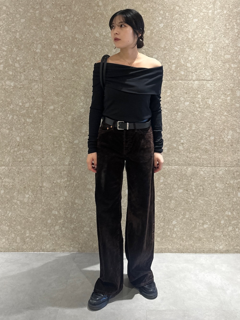 ブラック系のTシャツ/カットソー、ブラウン系のデニムパンツ、ブラック系のトートバッグを着用したレディースの秋コーディネートの2枚目の写真