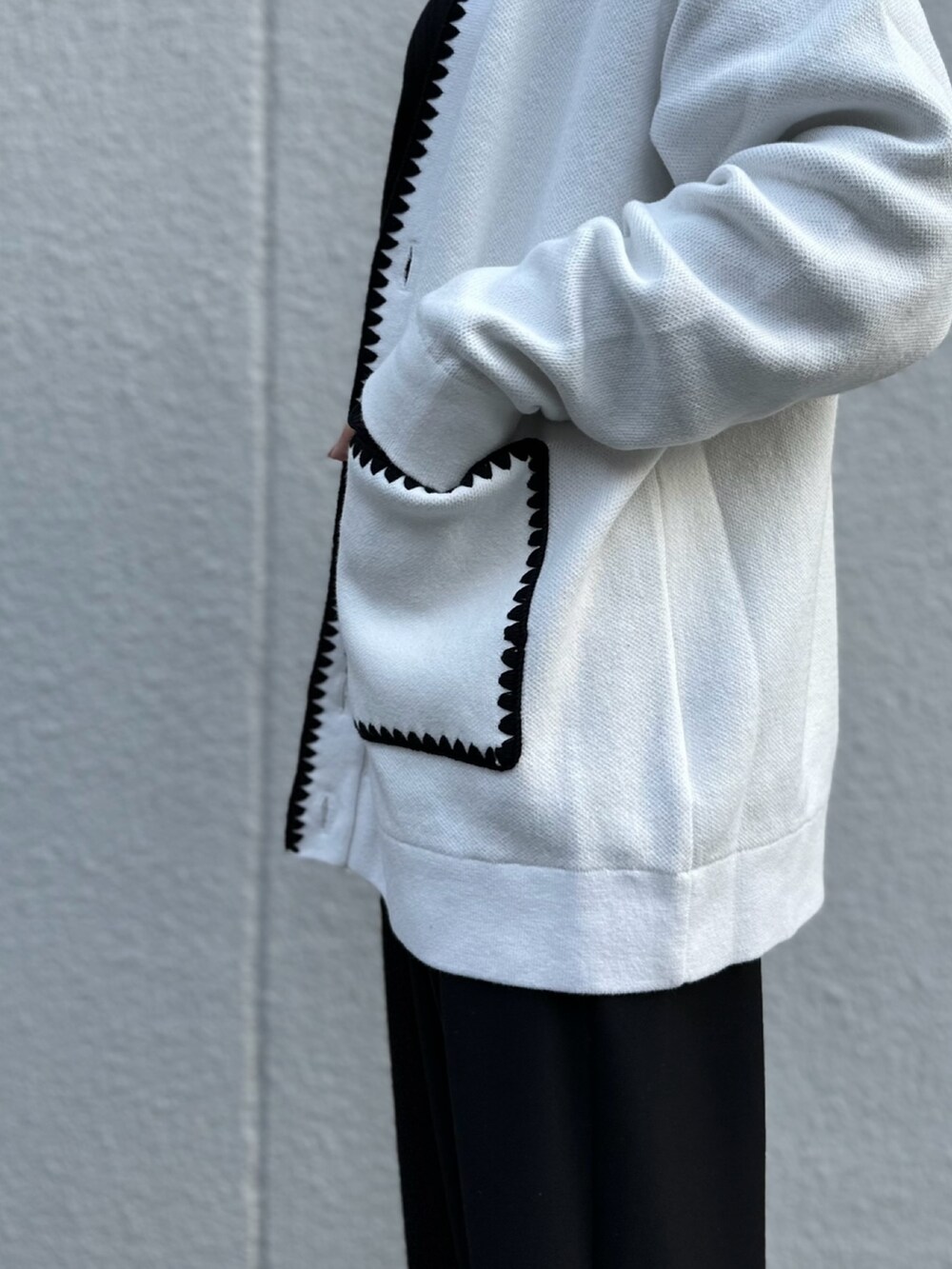 ホワイト系のカーディガン/ボレロ、ブラック系のTシャツ/カットソー、ブラック系のその他パンツを着用したレディースの冬コーディネートの3枚目の写真