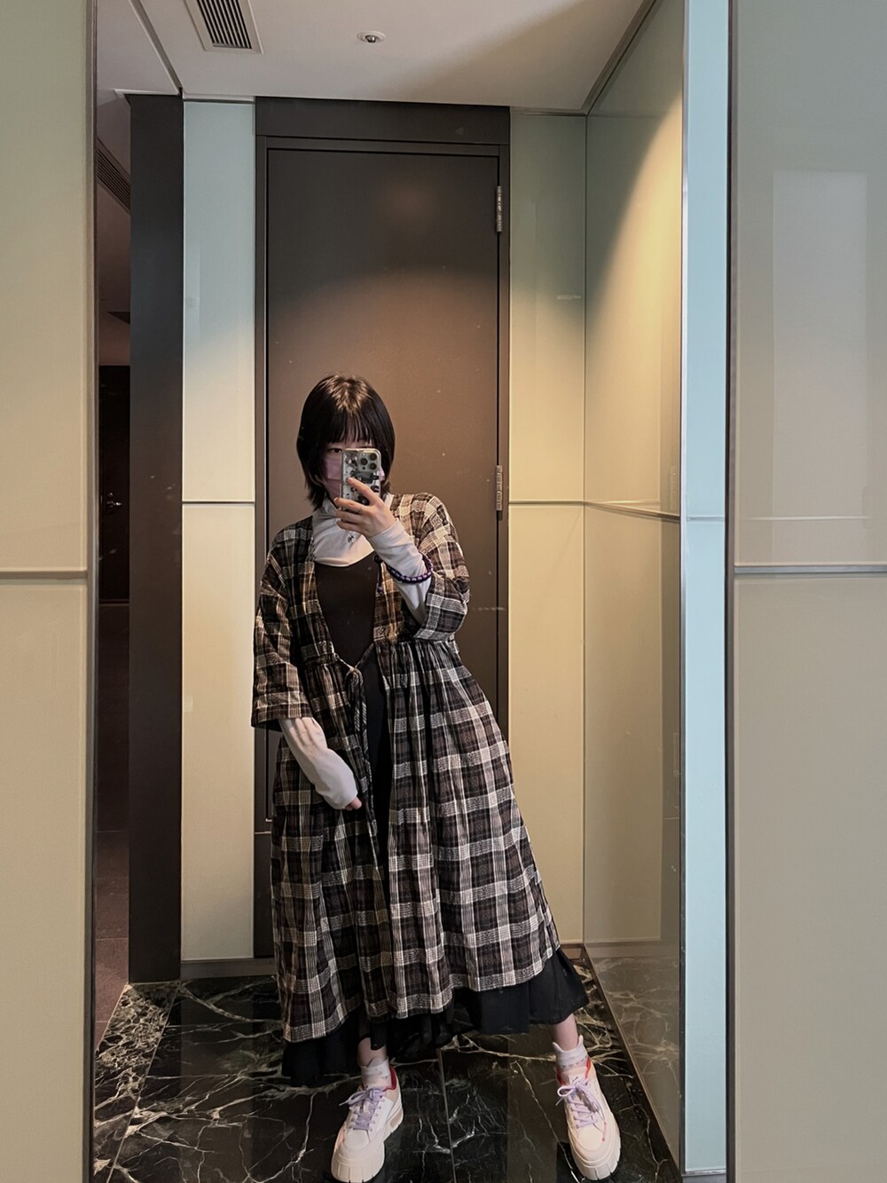 ブラック系のジャケット/アウター、グレー系のトップス、ホワイト系のスニーカーを着用したレディースの冬コーディネートの2枚目の写真