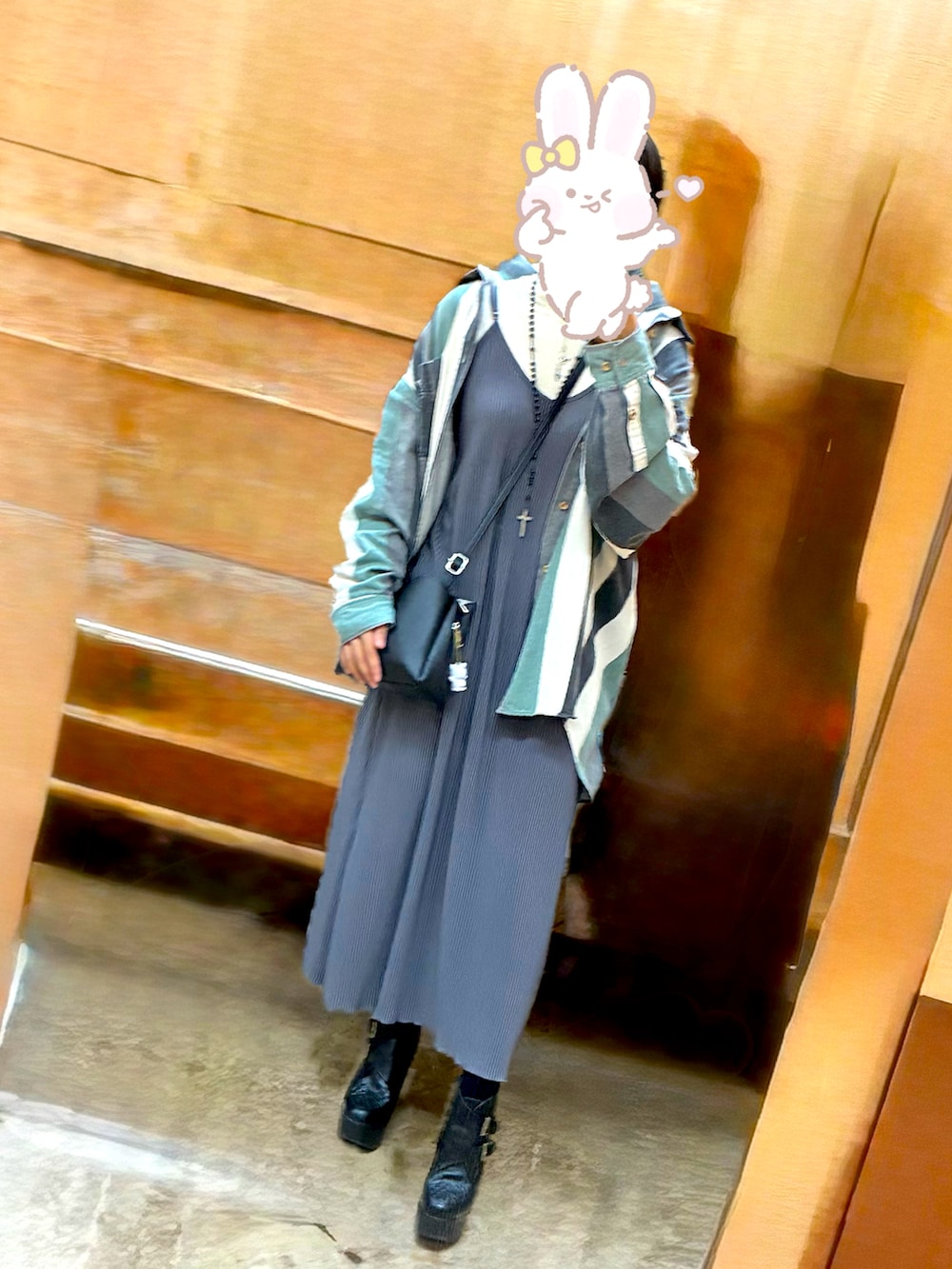 ブラック系のブーティ、グレー系のワンピース、ブラック系のショルダーバッグを着用したレディースの秋コーディネートの2枚目の写真