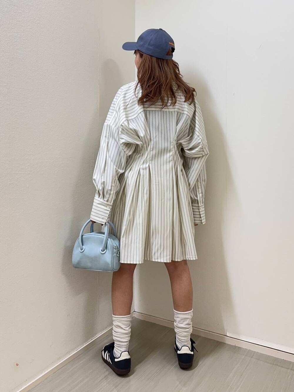 ブルー系のボストンバッグ、ホワイト系のその他パンツ、ベージュ系のワンピースを着用したレディースの冬コーディネートの3枚目の写真