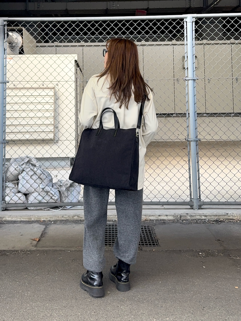 グレー系のその他パンツ、ホワイト系のシャツ/ブラウス、グレー系のトートバッグを着用したレディースの冬コーディネートの3枚目の写真