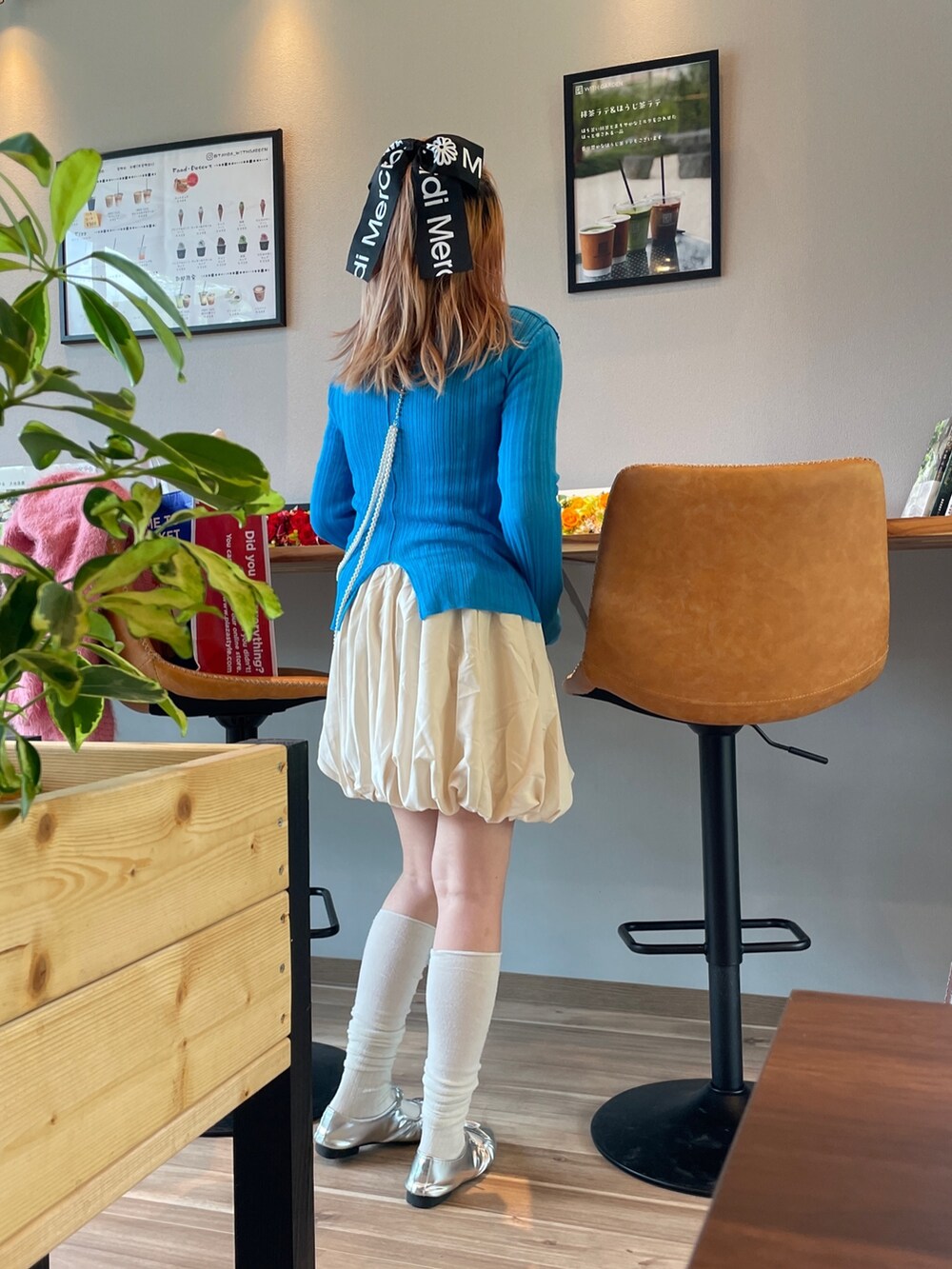 ブルー系のニット/セーター、シルバー系のネックレスを着用したレディースの春コーディネートの3枚目の写真