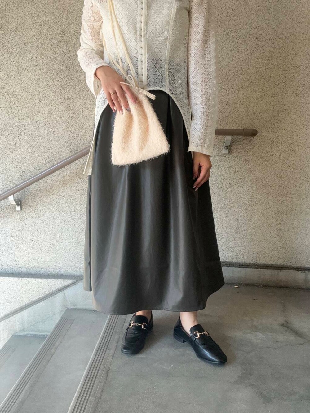 ホワイト系のショルダーバッグ、ホワイト系のTシャツ/カットソー、ブラウン系のスカートを着用したレディースの秋コーディネートの6枚目の写真