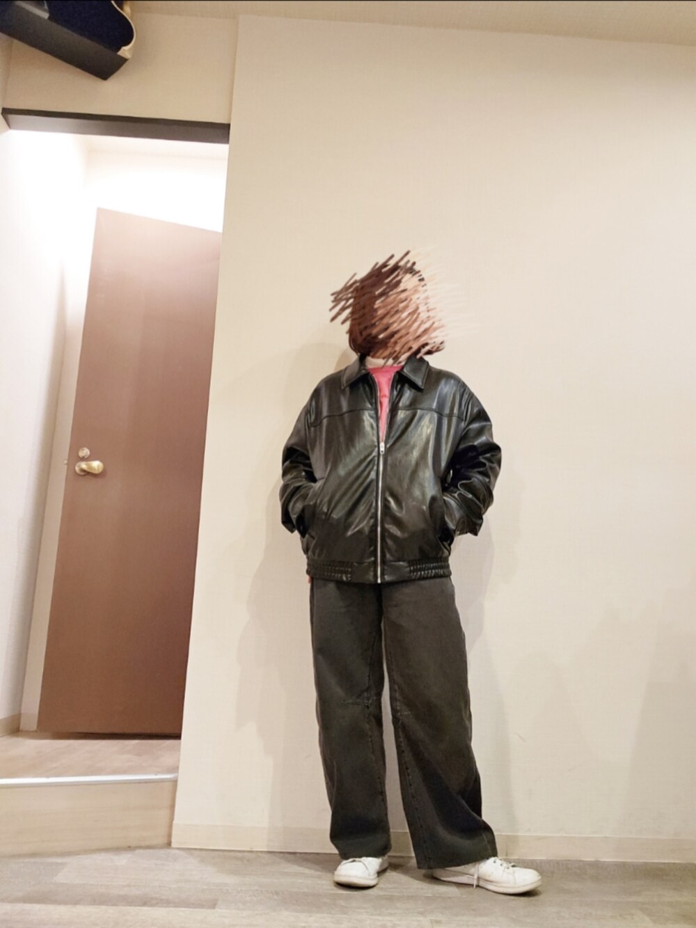 ブラック系のデニムパンツ、ピンク系のスウェット、ホワイト系のTシャツ/カットソーを着用したレディースの冬コーディネートの2枚目の写真
