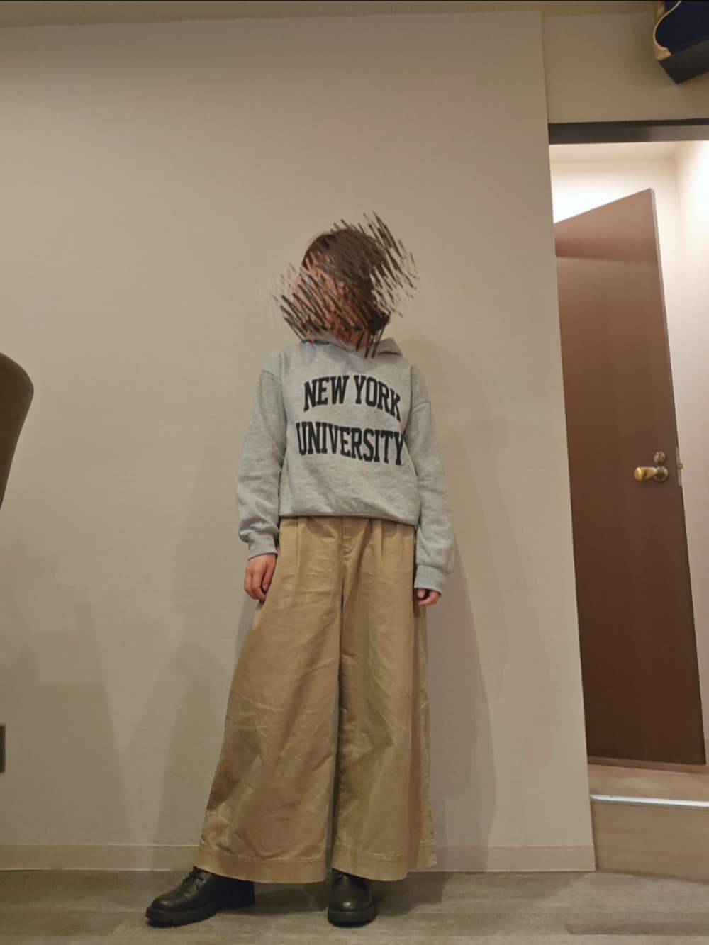 グリーン系のマウンテンパーカー、グレー系のパーカー、ベージュ系のチノパンツを着用したレディースの春コーディネートの2枚目の写真