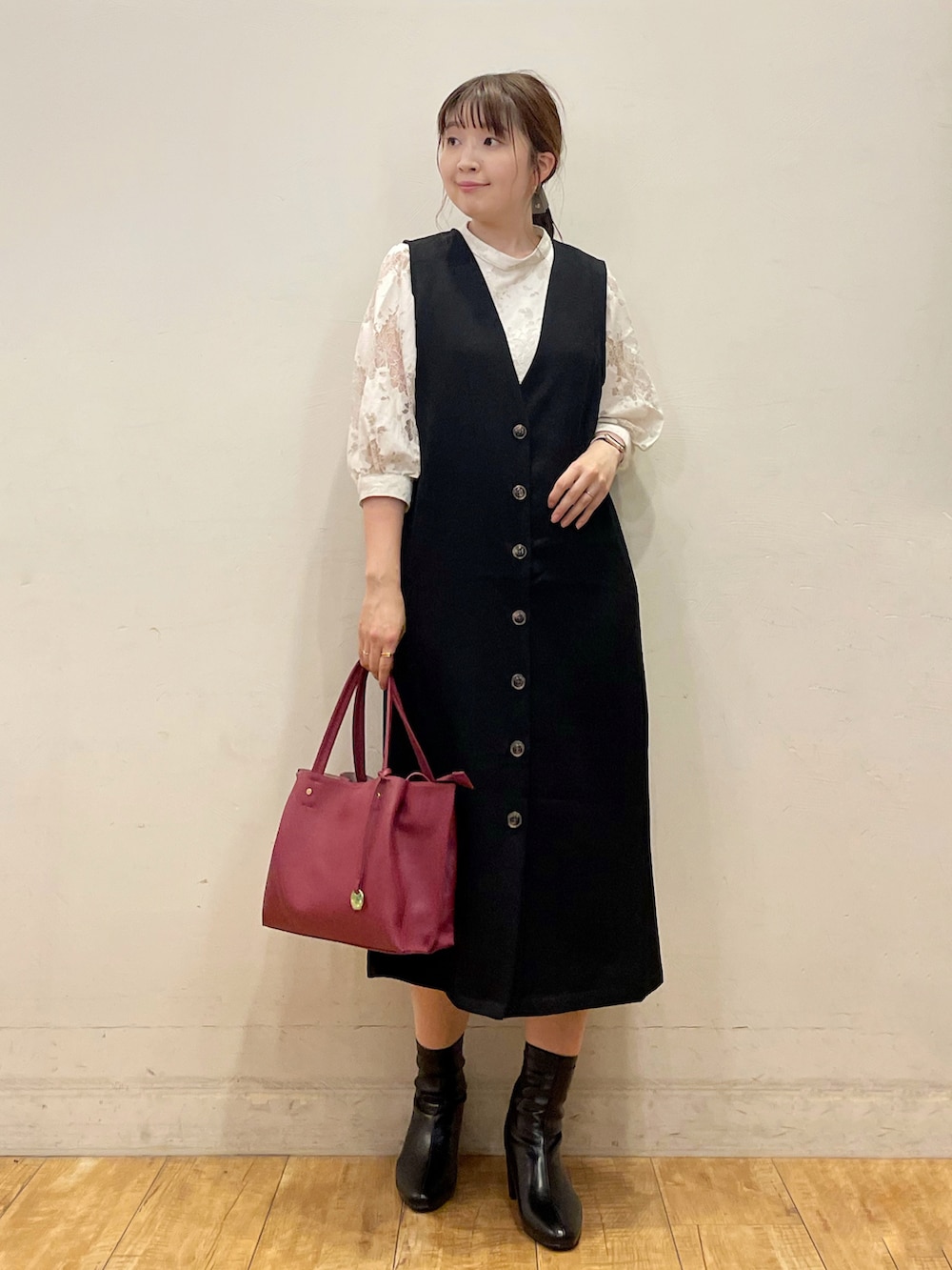 ホワイト系のTシャツ/カットソー、ブラック系のスカート、ブラック系のブーツを着用したレディースの秋コーディネートの2枚目の写真