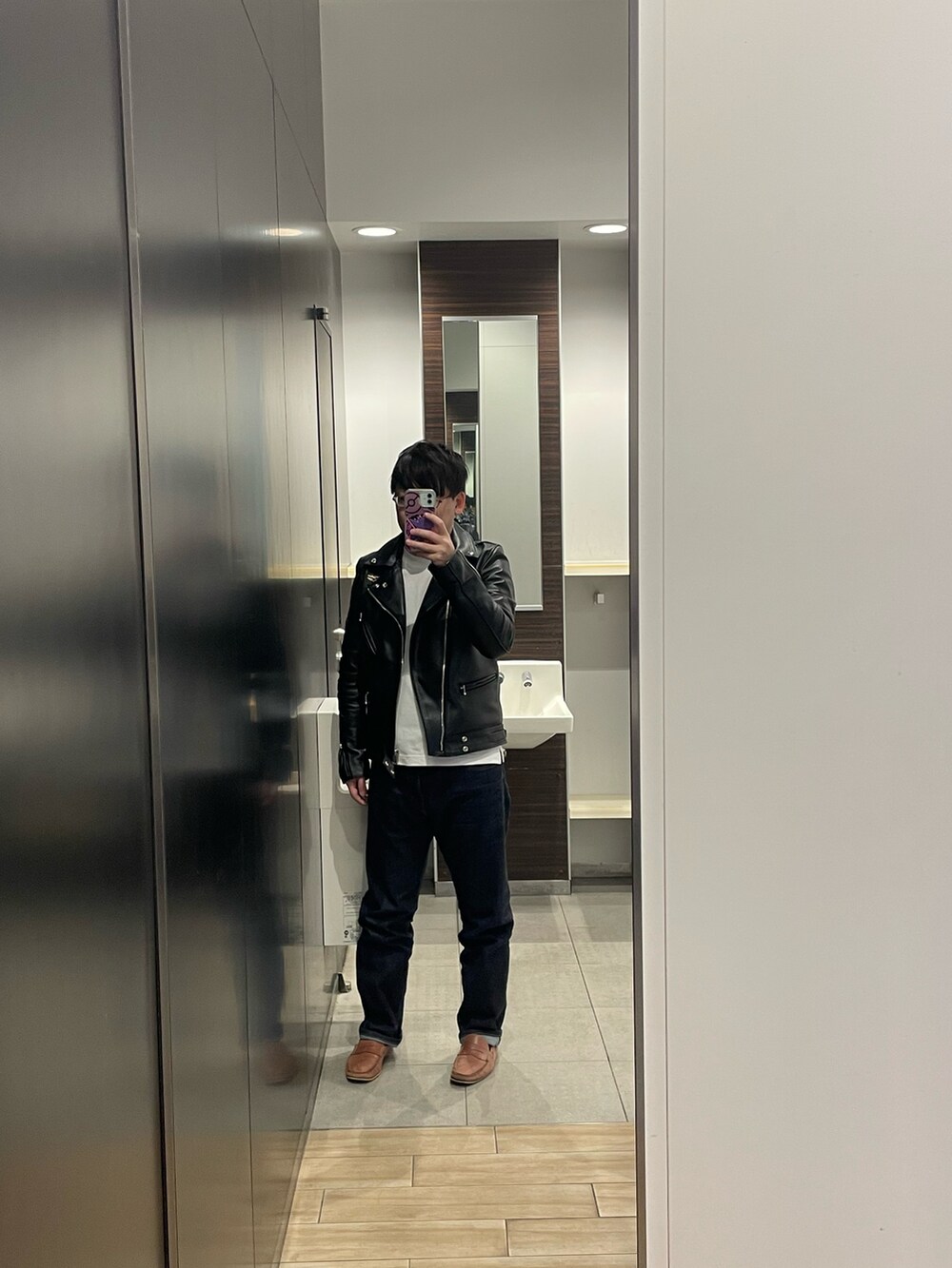 ブルー系のデニムパンツ、ブラック系のライダースジャケット、ホワイト系のTシャツ/カットソーを着用したメンズの冬コーディネートの2枚目の写真