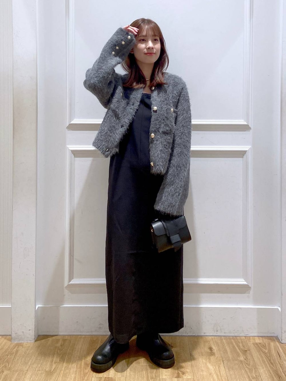 グレー系のカーディガン/ボレロ、ホワイト系のワンピース、ブラック系のショルダーバッグを着用したレディースの冬コーディネートの3枚目の写真