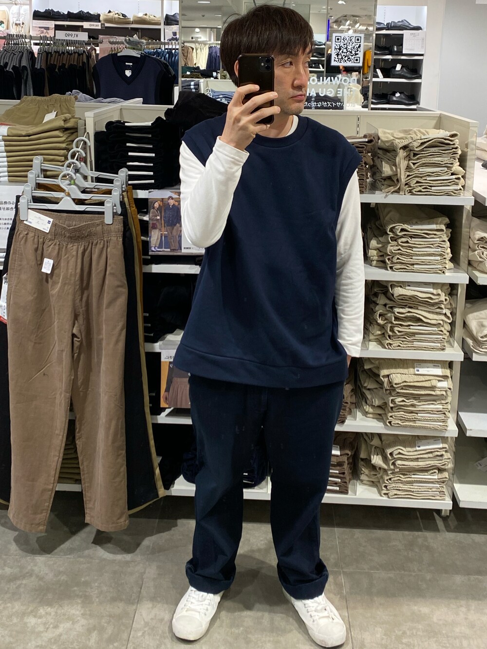 ブルー系のその他パンツ、ホワイト系のスニーカー、ブルー系のベストを着用したメンズの秋コーディネートの3枚目の写真