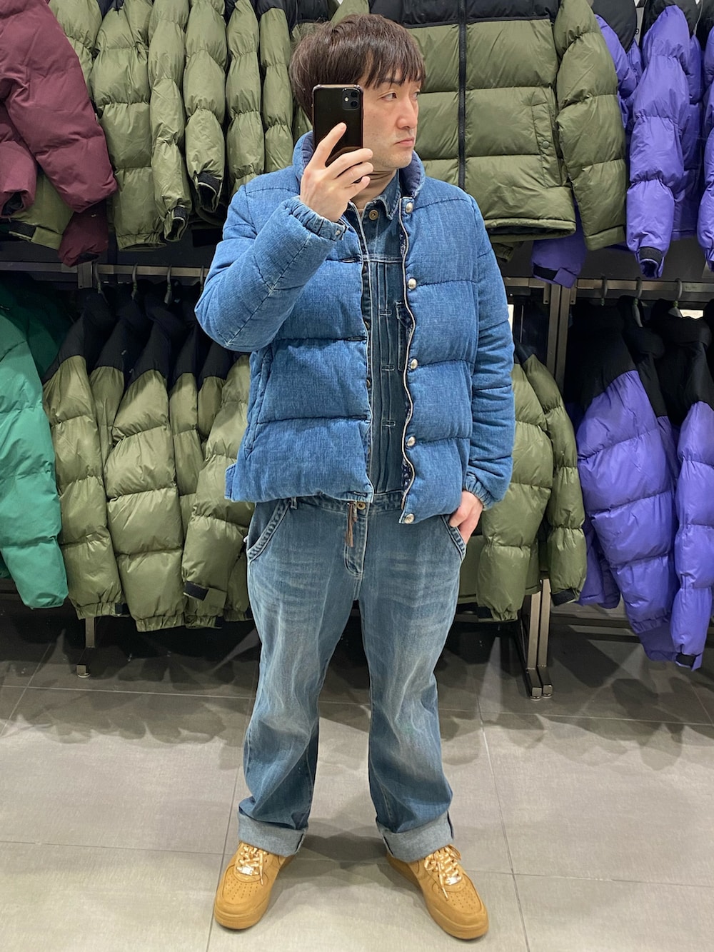 ブルー系のダウンジャケット/コート、ブルー系のつなぎ/オールインワン、ブラウン系のスニーカーを着用したメンズの冬コーディネートの3枚目の写真