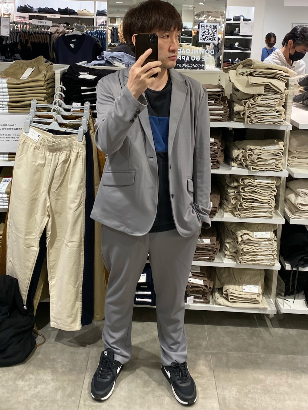 グレー系のセットアップ、ブラック系のスニーカー、ブラック系のTシャツ/カットソーを着用したメンズの秋コーディネートの4枚目の写真