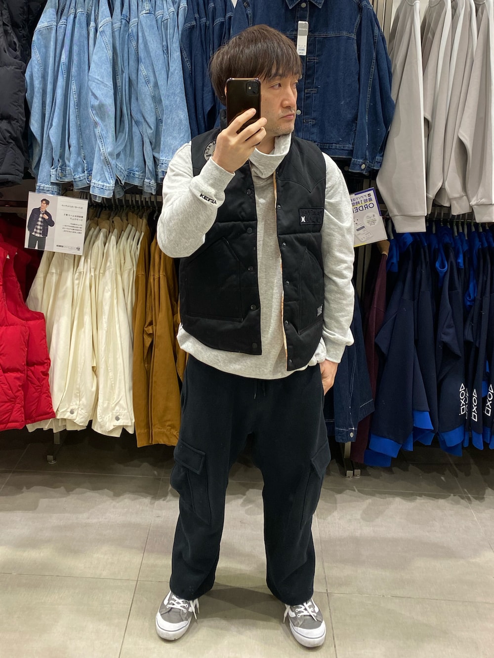 ブラック系のスウェット、ブラック系のカーゴパンツ、グレー系のスニーカーを着用したメンズの秋コーディネートの3枚目の写真