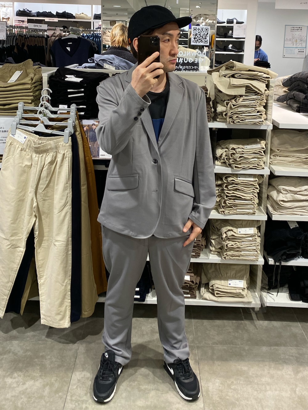 グレー系のセットアップ、ブラック系のスニーカー、ブラック系のTシャツ/カットソーを着用したメンズの秋コーディネートの2枚目の写真