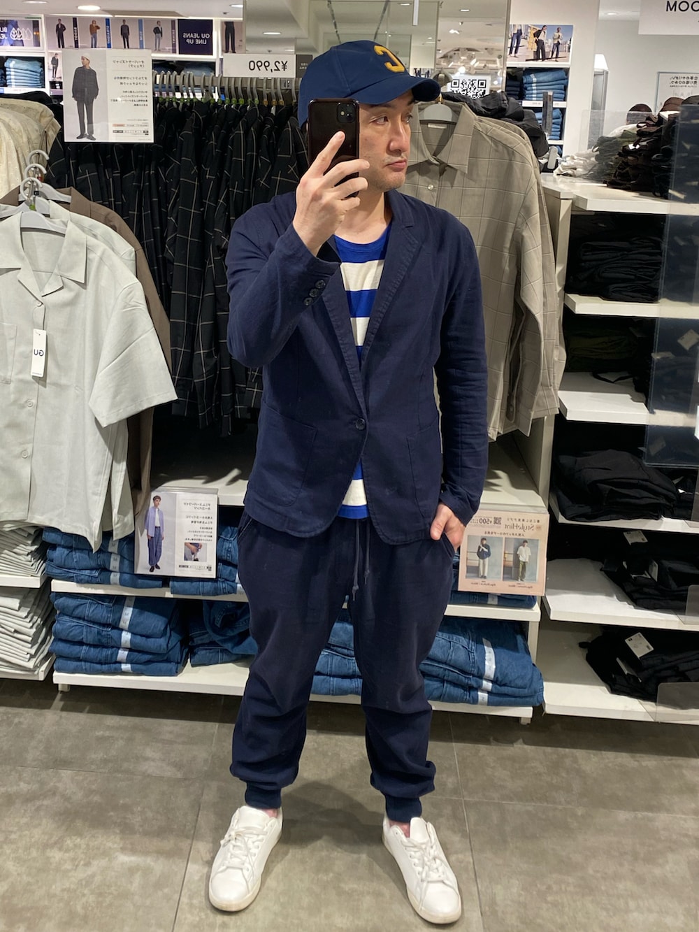 ブルー系のテーラードジャケット、ブルー系のその他パンツ、ホワイト系のスニーカーを着用したメンズの秋コーディネートの2枚目の写真