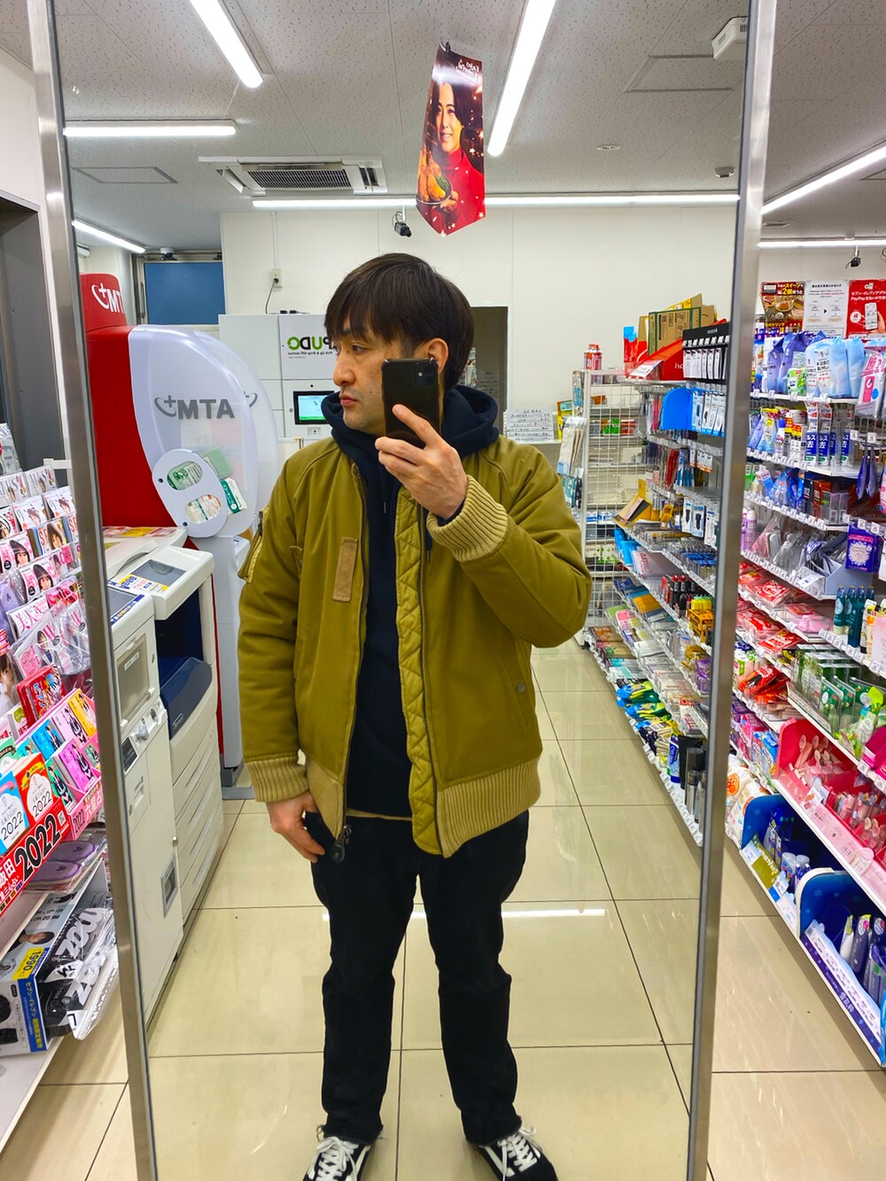 ブラック系のパーカー、ブラック系のデニムパンツ、ブラック系のスニーカーを着用したメンズの冬コーディネートの3枚目の写真