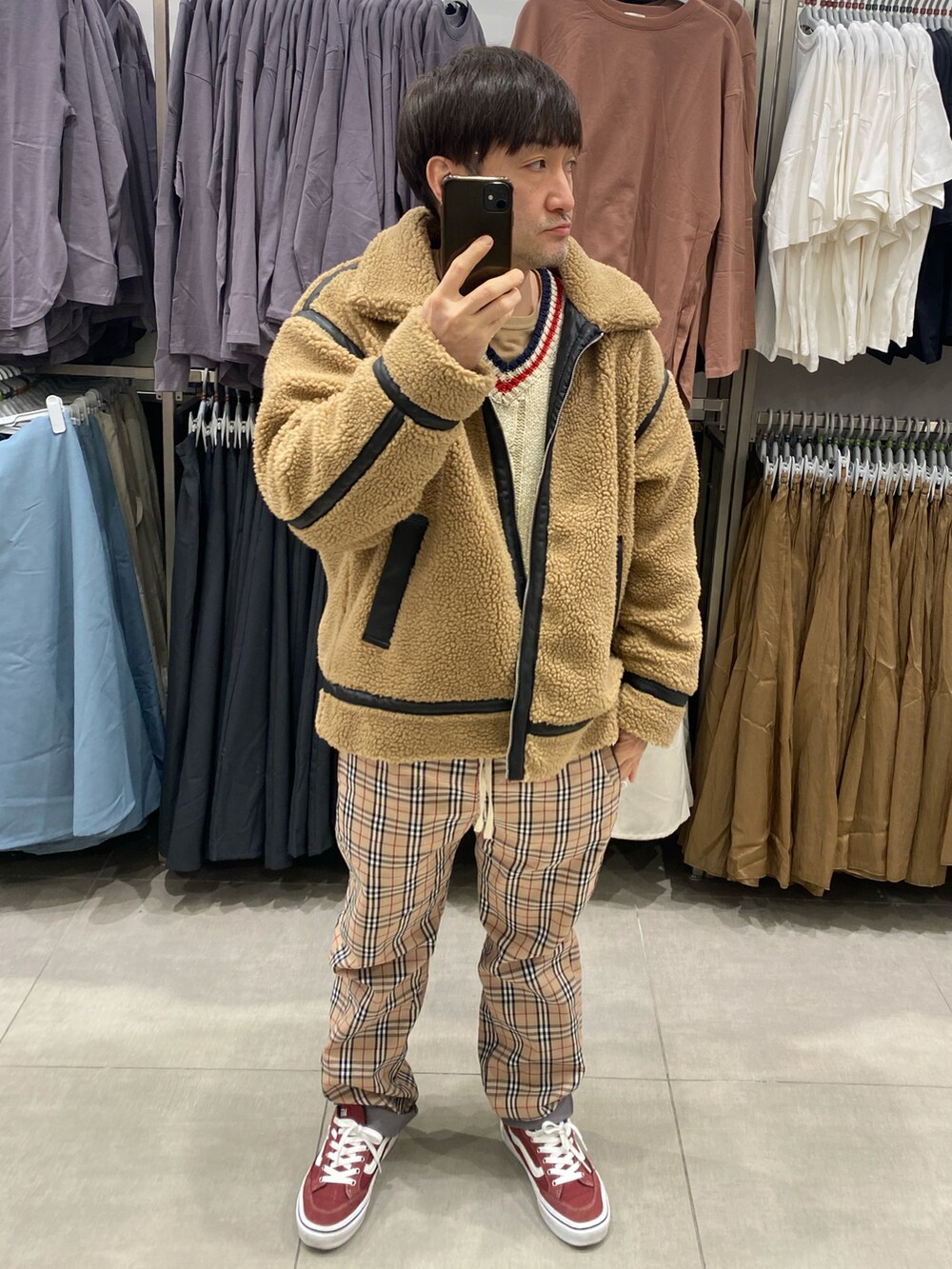 ベージュ系のブルゾン、ホワイト系のニット/セーター、ベージュ系のパンツを着用したメンズの冬コーディネートの3枚目の写真