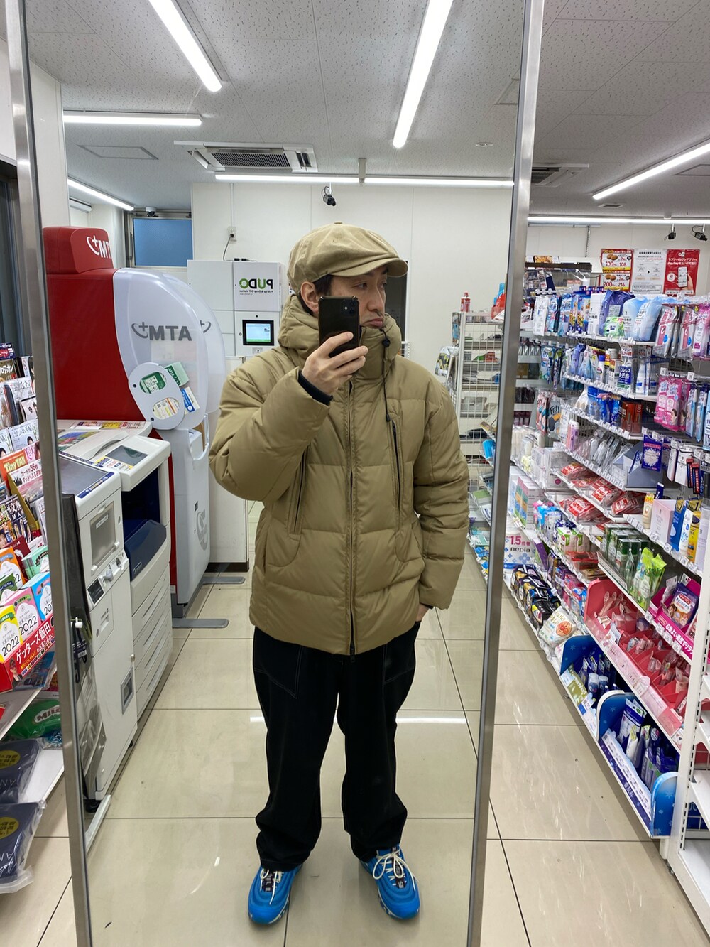 ブラック系のTシャツ/カットソー、ベージュ系のダウンジャケット/コート、ブルー系のセットアップを着用したメンズの冬コーディネートの3枚目の写真