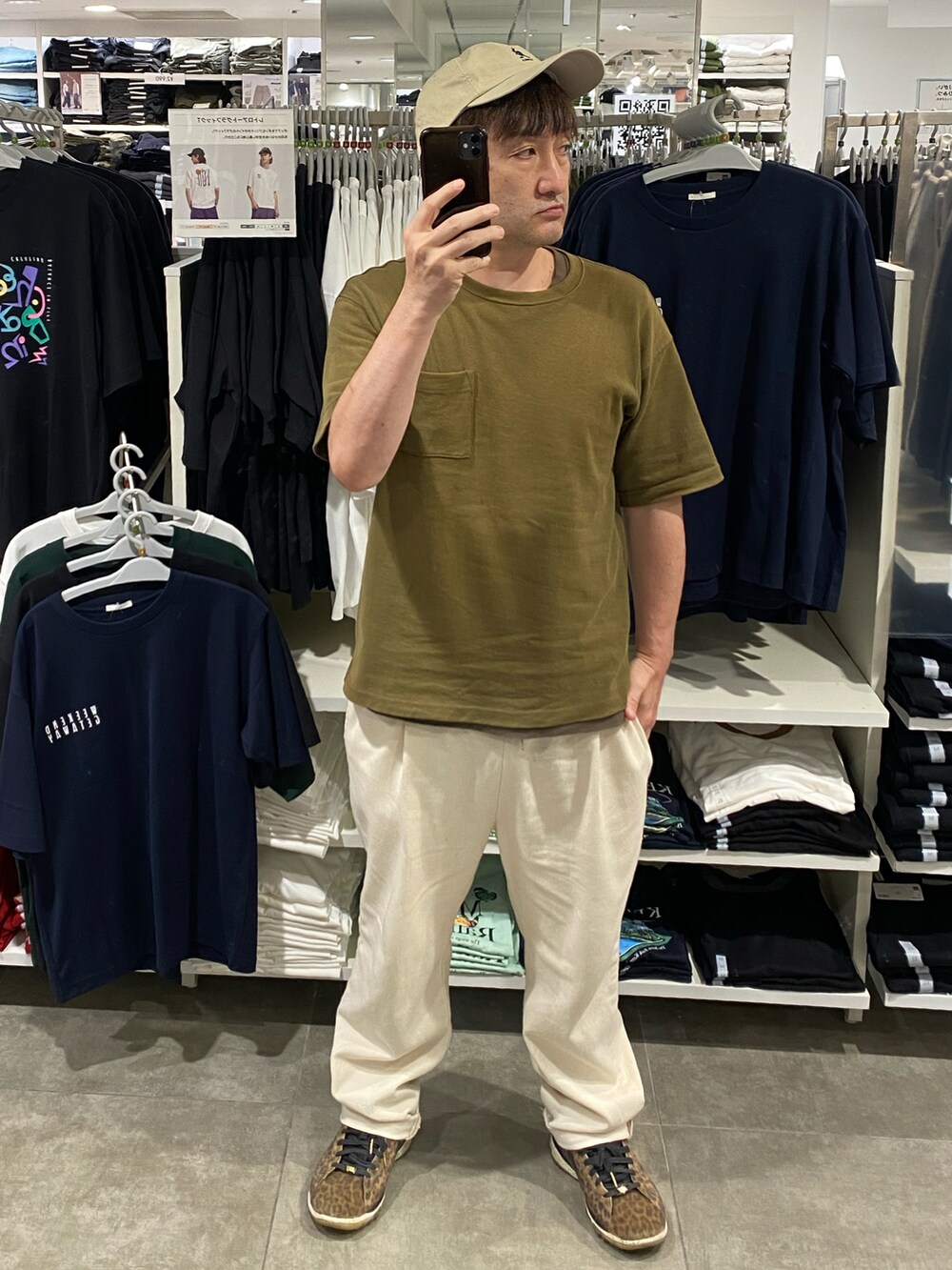 グリーン系のTシャツ/カットソー、ホワイト系のスラックス、その他のスニーカーを着用したメンズの夏コーディネートの2枚目の写真