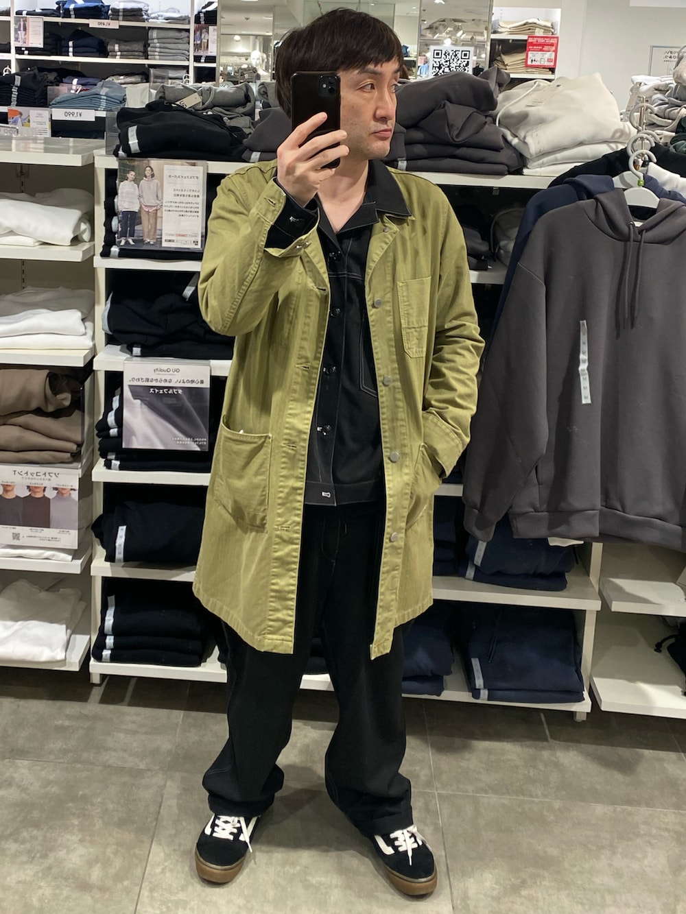 ブラック系のセットアップ、グリーン系のその他アウター、ブラック系のスニーカーを着用したメンズの春コーディネートの4枚目の写真