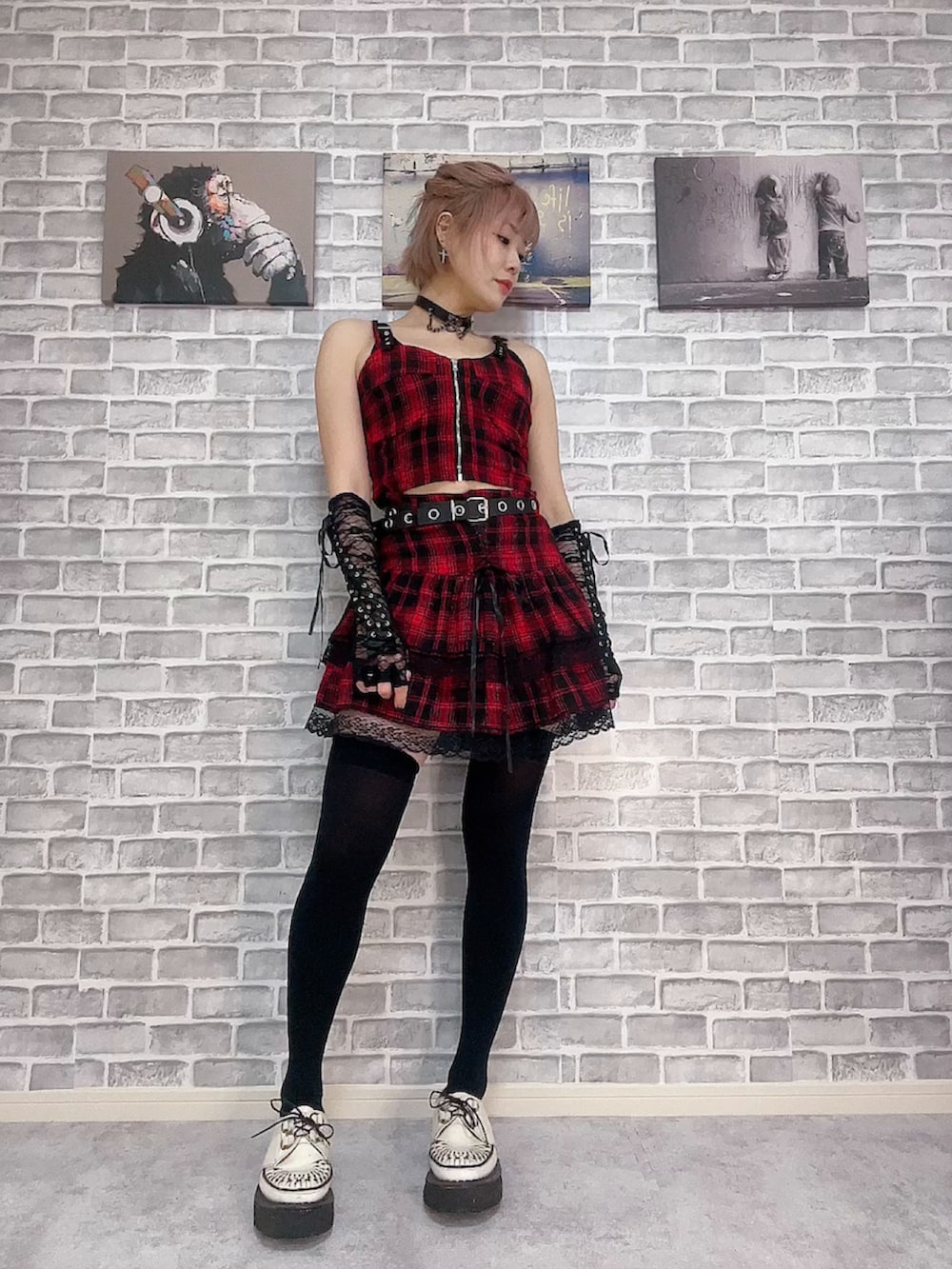 レッド系のキャミソール、レッド系のスカート、ホワイト系のその他シューズを着用したレディースの冬コーディネートの2枚目の写真