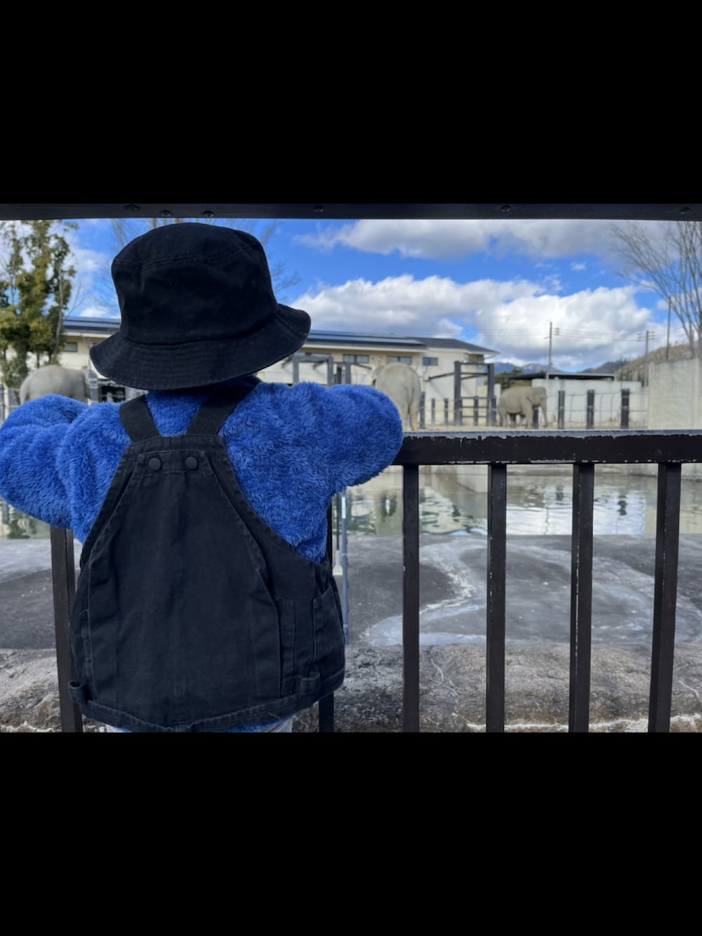 ブラック系のベスト、ホワイト系のベスト、グリーン系のモッズコートを着用したレディースの冬コーディネートの3枚目の写真