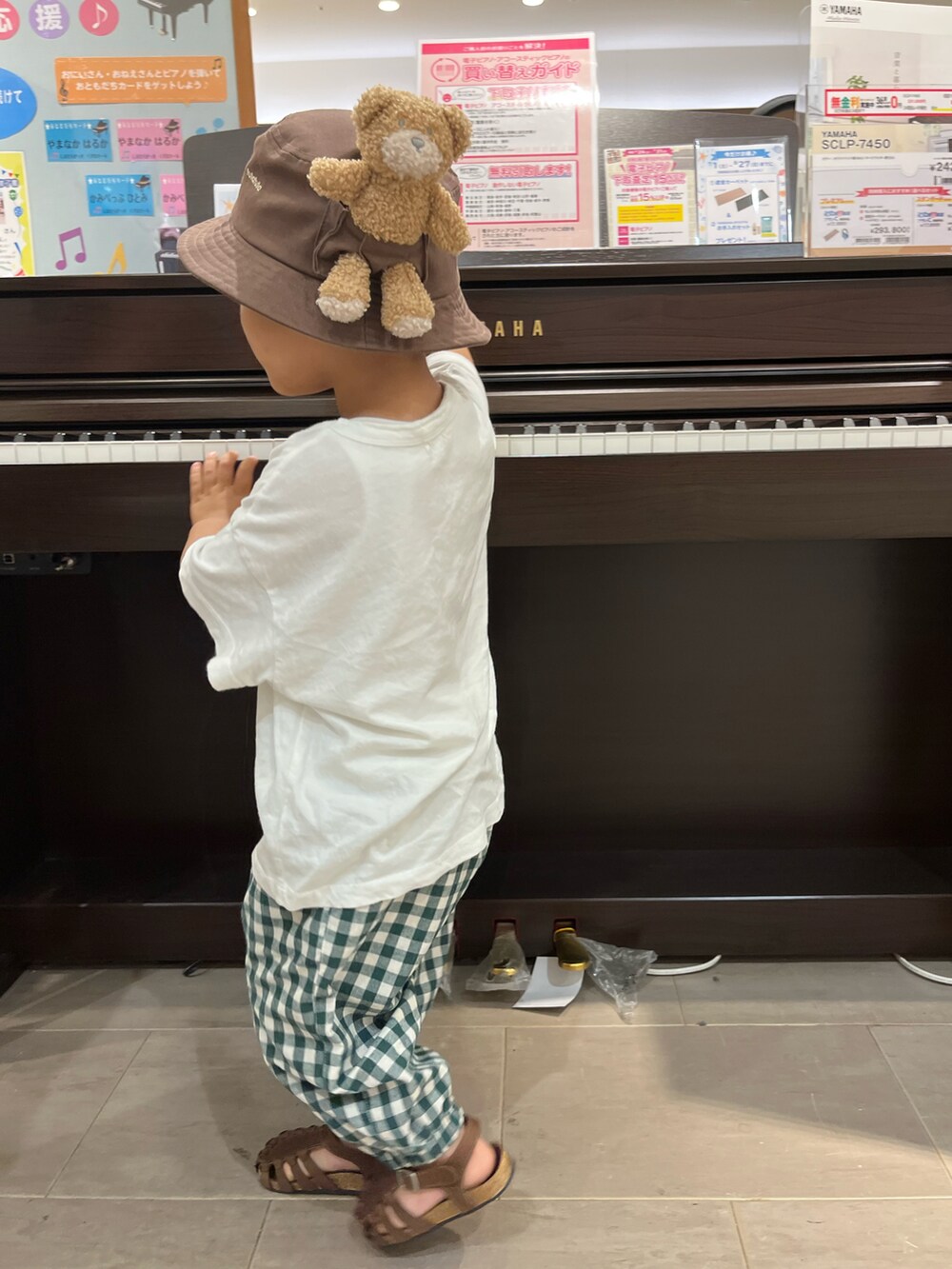 ホワイト系のTシャツ/カットソー、グリーン系のパンツ、ブラウン系のサンダルを着用したキッズの夏コーディネートの2枚目の写真