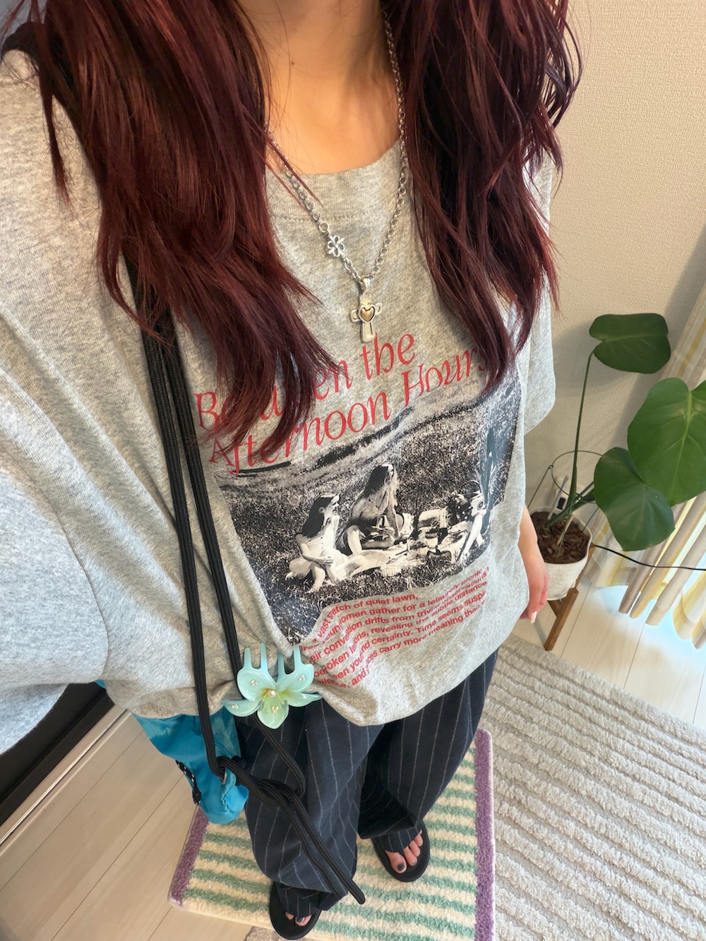 ブルー系のバックパック/リュック、ブラック系のサンダル、グレー系のTシャツ/カットソーを着用したレディースの夏コーディネートの2枚目の写真