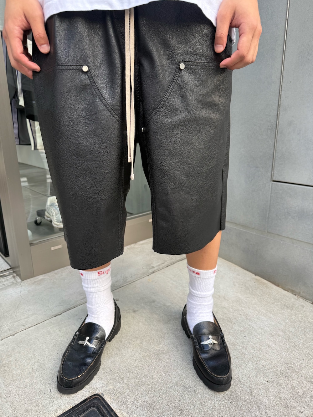 ホワイト系のTシャツ/カットソー、ブラック系のその他パンツ、ブラック系のローファーを着用したメンズの夏コーディネートの5枚目の写真