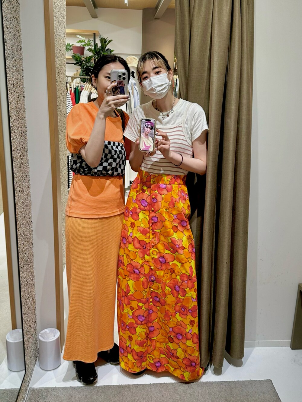 オレンジ系のTシャツ/カットソー、ブラック系のその他トップス、オレンジ系のスカートを着用したレディースの夏コーディネートの3枚目の写真