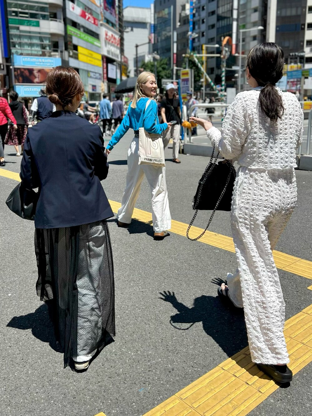 ホワイト系のシャツ/ブラウス、ホワイト系のその他パンツ、ブラック系のハンドバッグを着用したレディースの春コーディネートの4枚目の写真