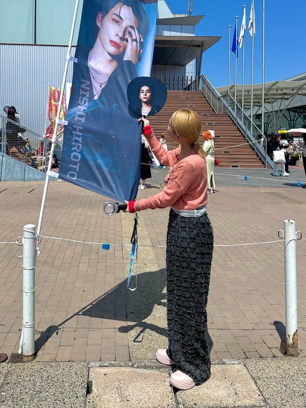 レッド系のTシャツ/カットソー、オレンジ系のカーディガン/ボレロ、ホワイト系のキャミソールを着用したレディースの春コーディネートの2枚目の写真